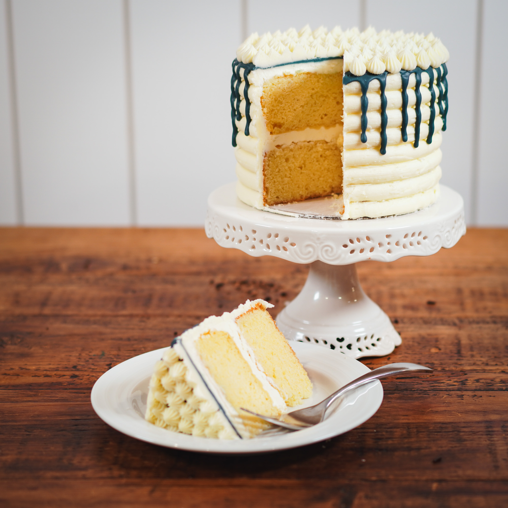Yellow cake with vanilla frosting and blue drip